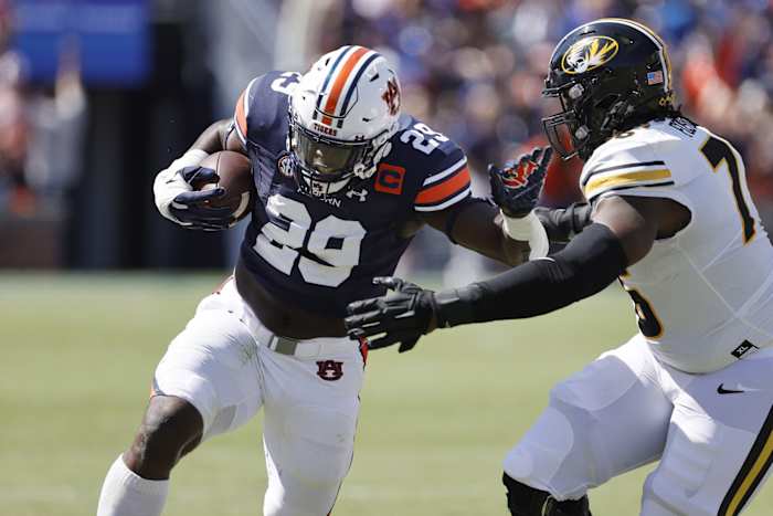 Sep 24, 2022; Auburn, Alabama, USA; Auburn Tigers linebacker Derick Hall (29) returns an interception as Missouri Tigers offensive lineman Javon Foster (76) goes for the tackle during the first quarter at Jordan-Hare Stadium. Mandatory Credit: John Reed-USA TODAY Sports